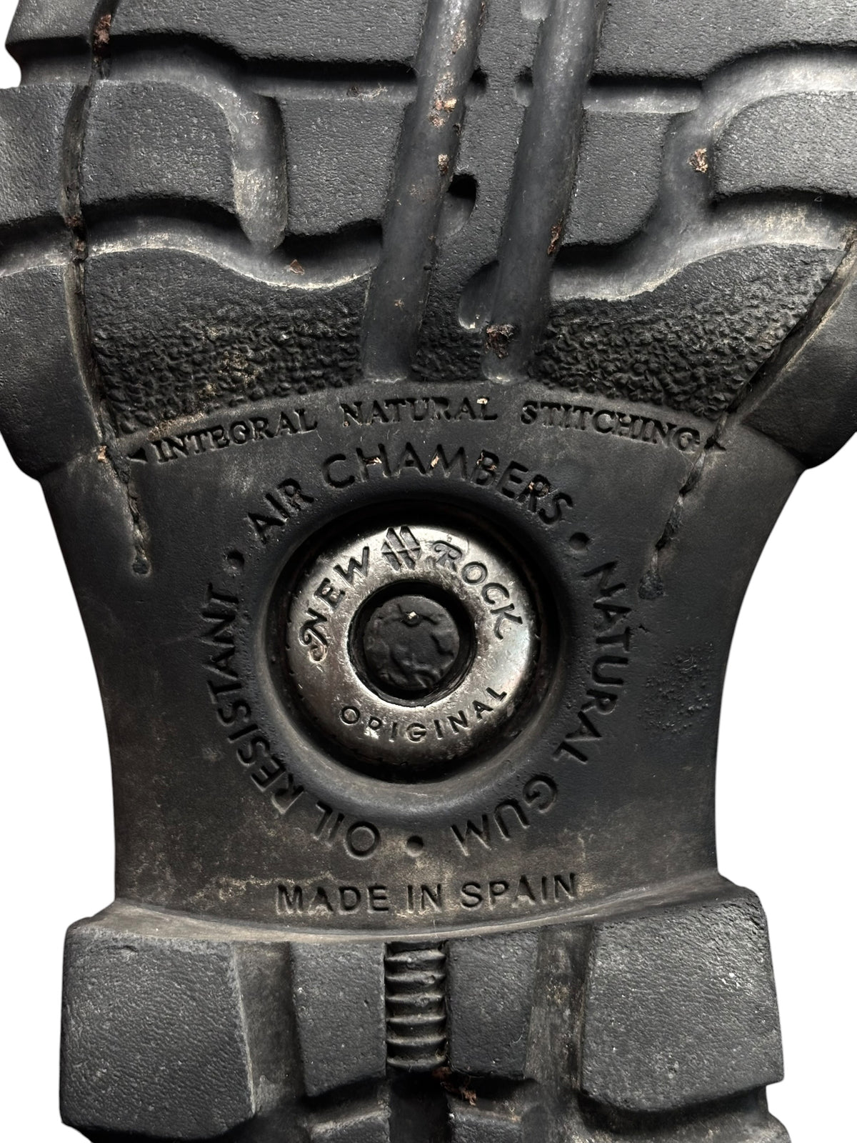 Rubber boot outsole tread with embossed maker stamp and stitching