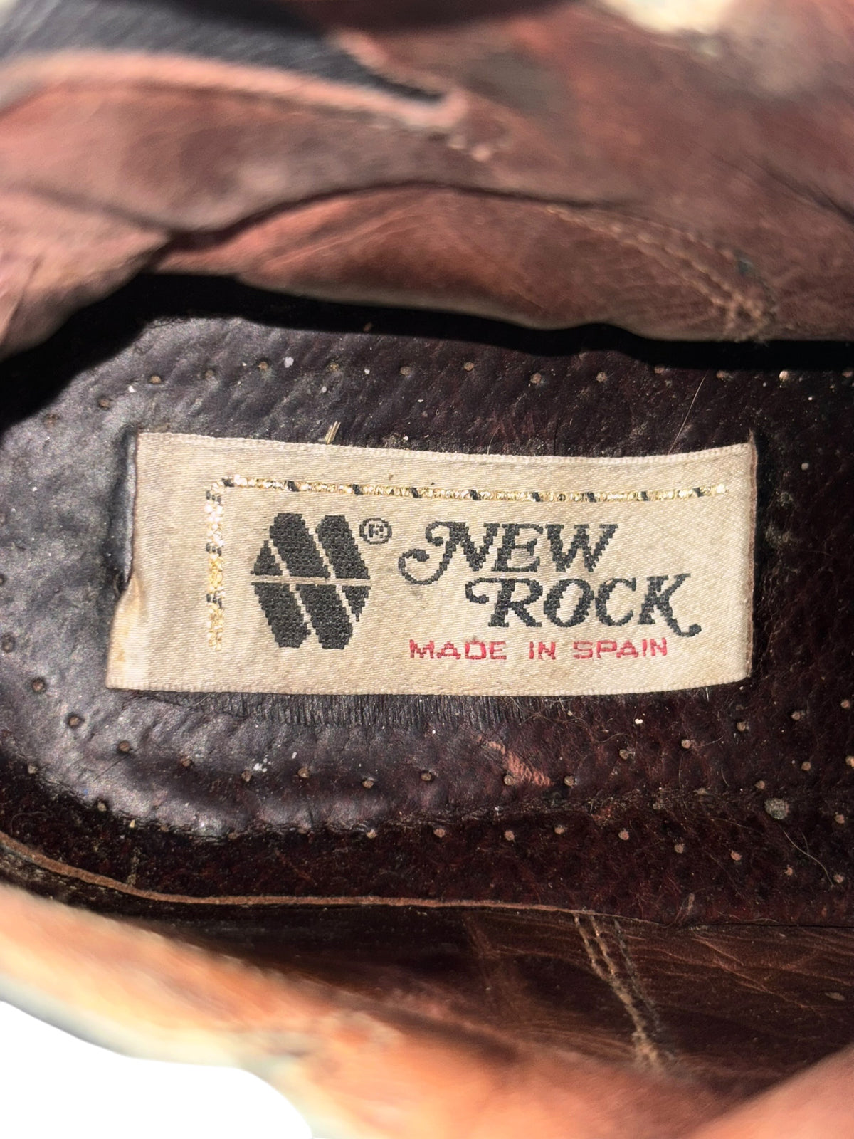 Knee-high leather boot with interior New Rock logo label near ankle opening