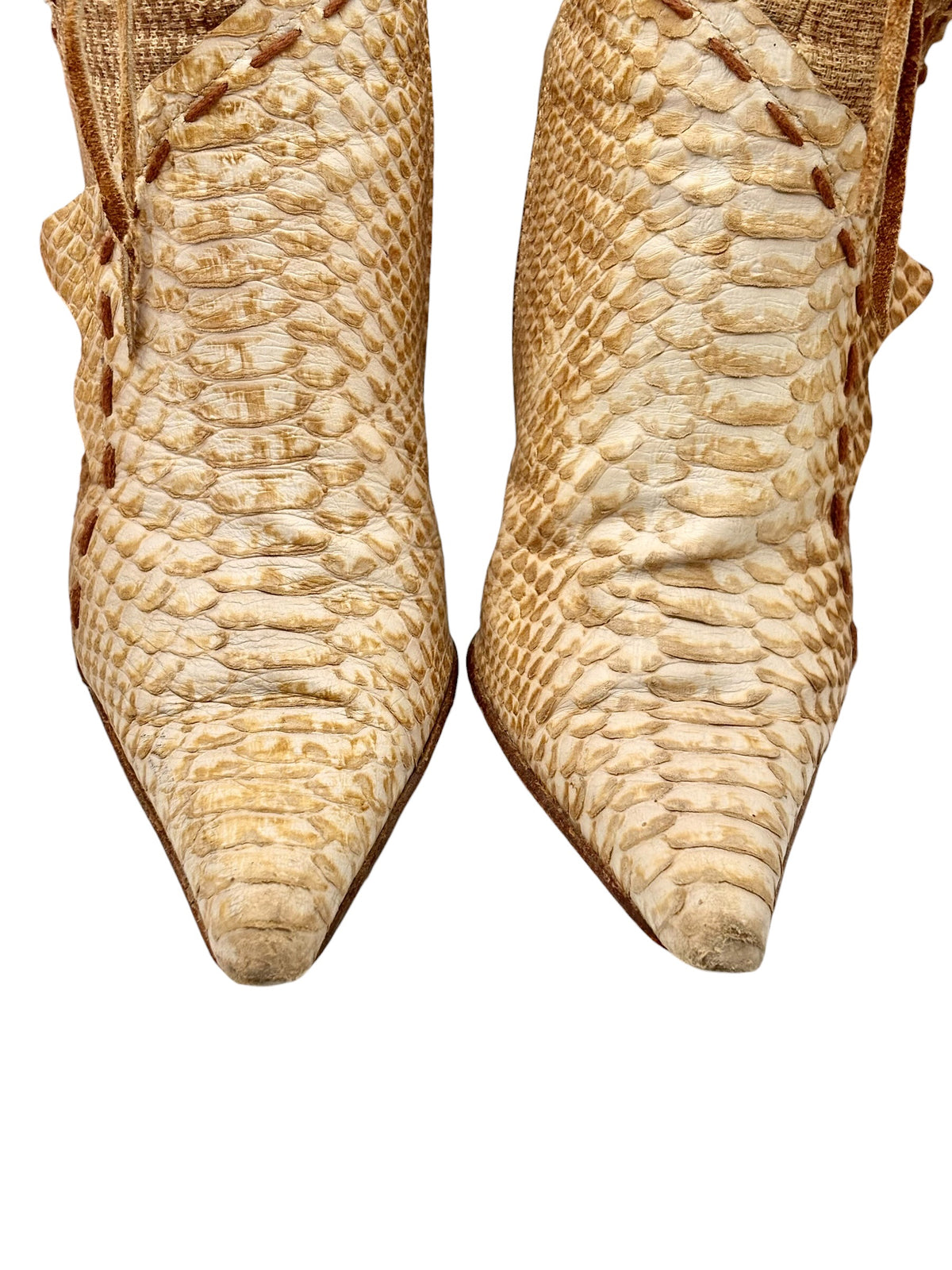 Beige snake-pattern leather boots, pointed toe close-up