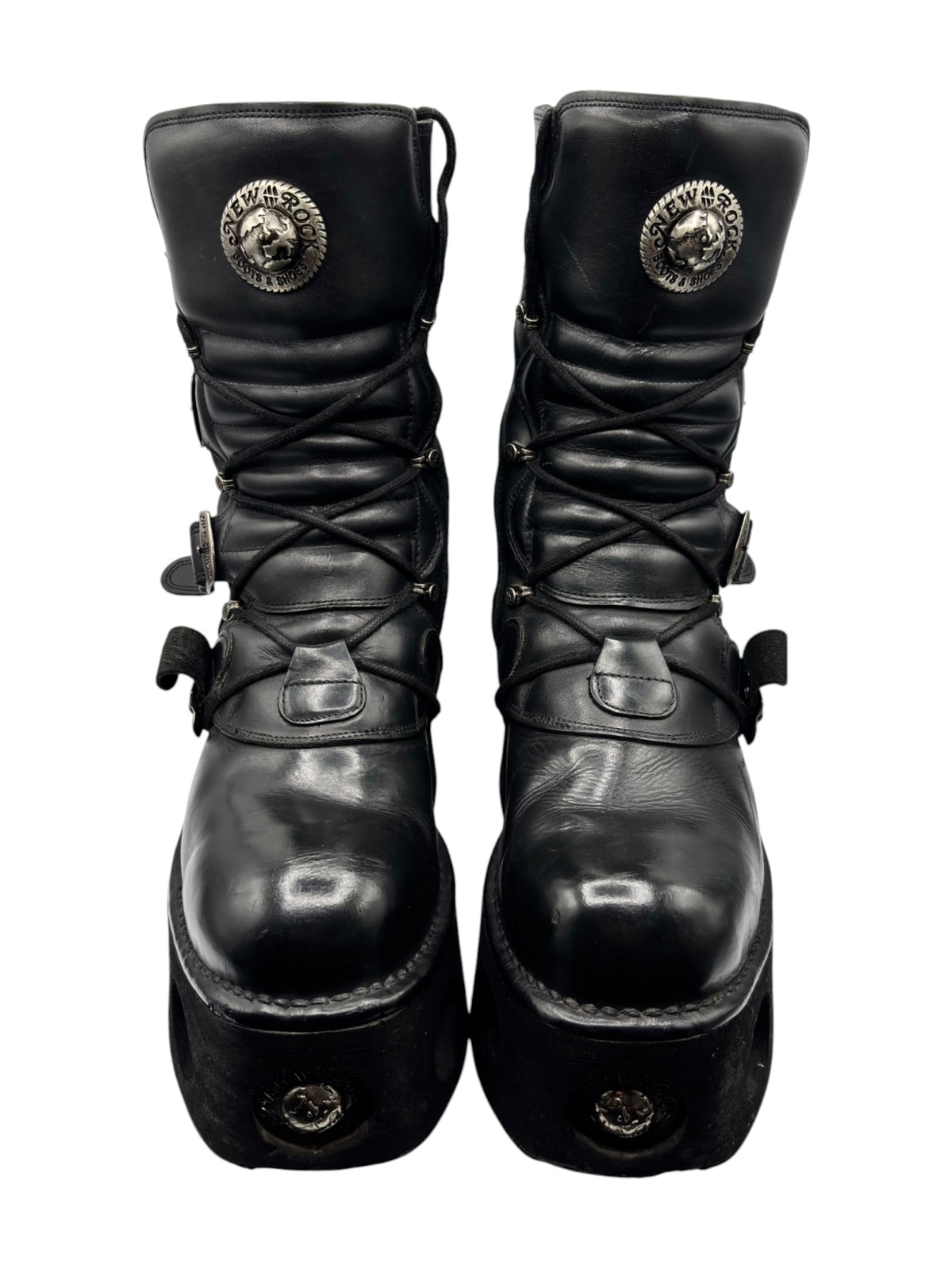 Black mid-calf platform boots with laces, buckles, and round logo caps