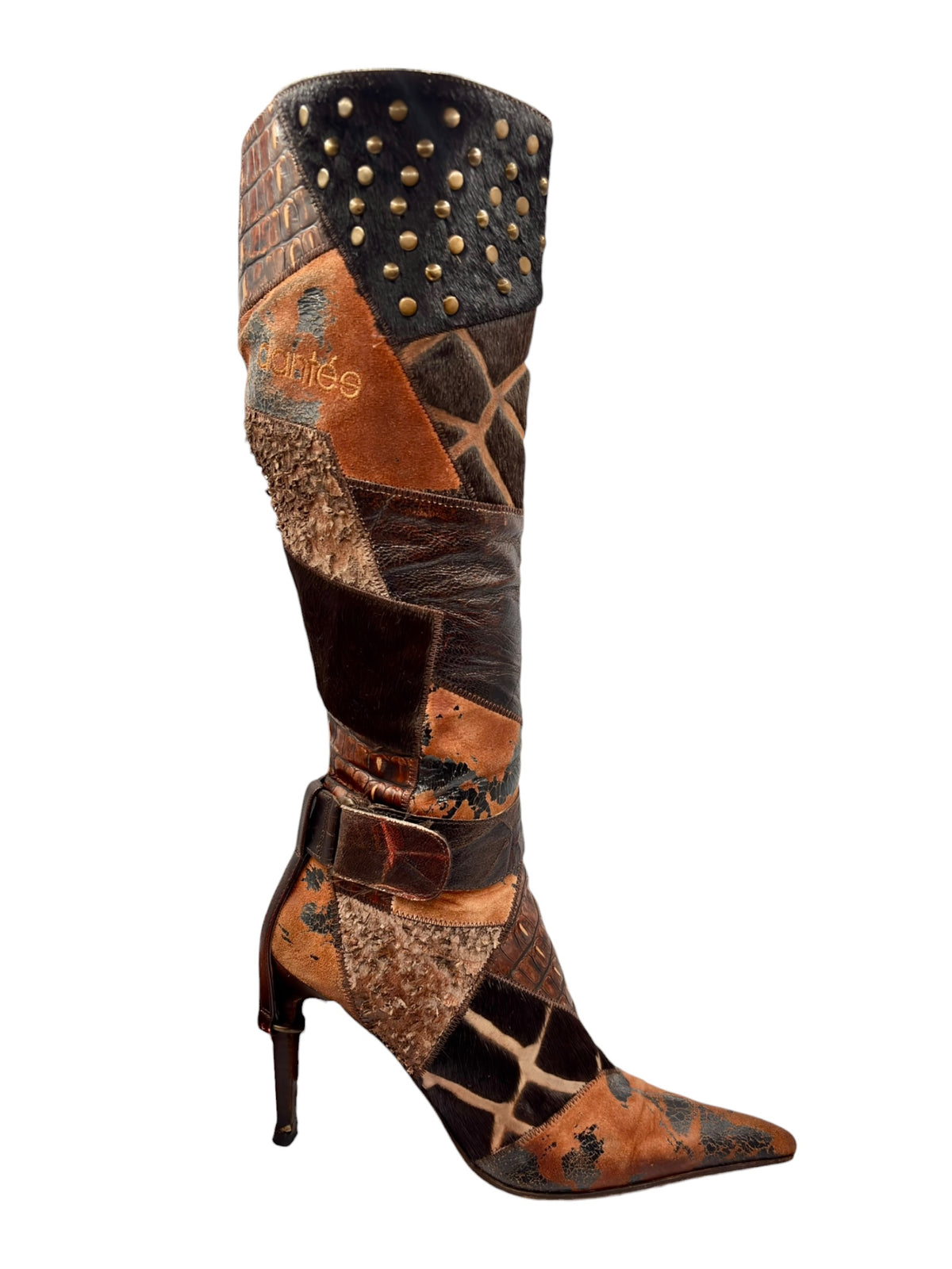 Knee-high patchwork boots with pointed toe, stiletto heel, and gold studs on dark shaft