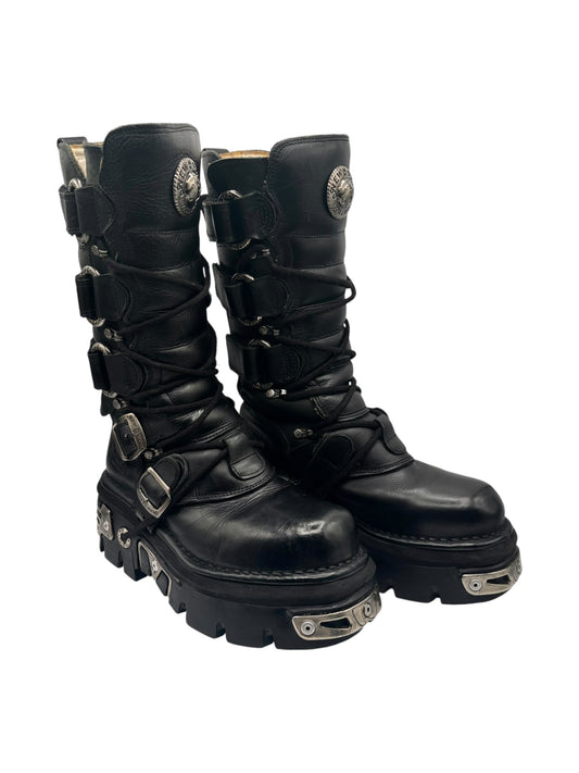 Black leather combat boots with straps and silver buckles, three-quarter side view