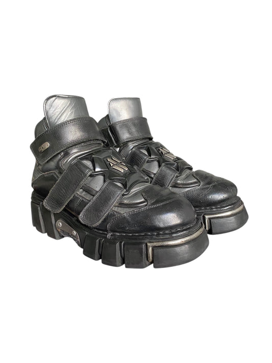 Black leather platform boots with multiple hook-and-loop straps, chunky lug sole
