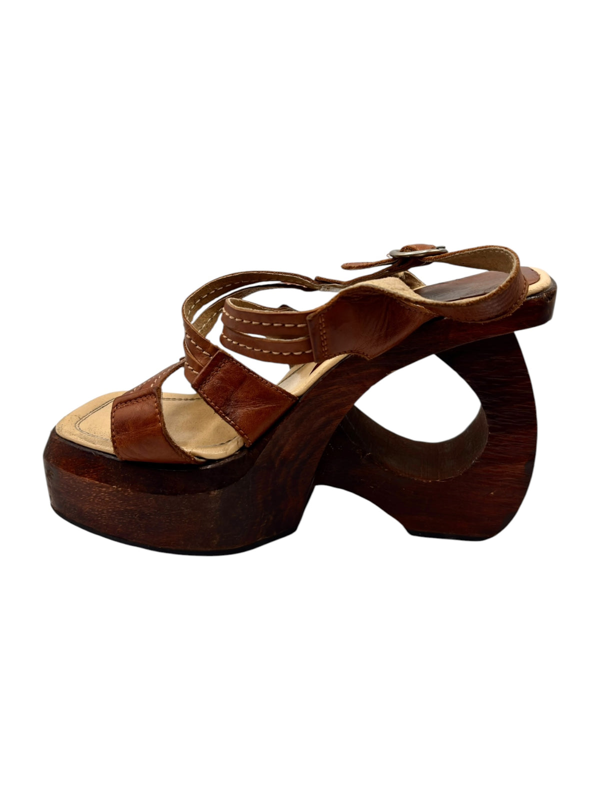 Brown leather platform sandal with ankle strap, buckle, and open toe design