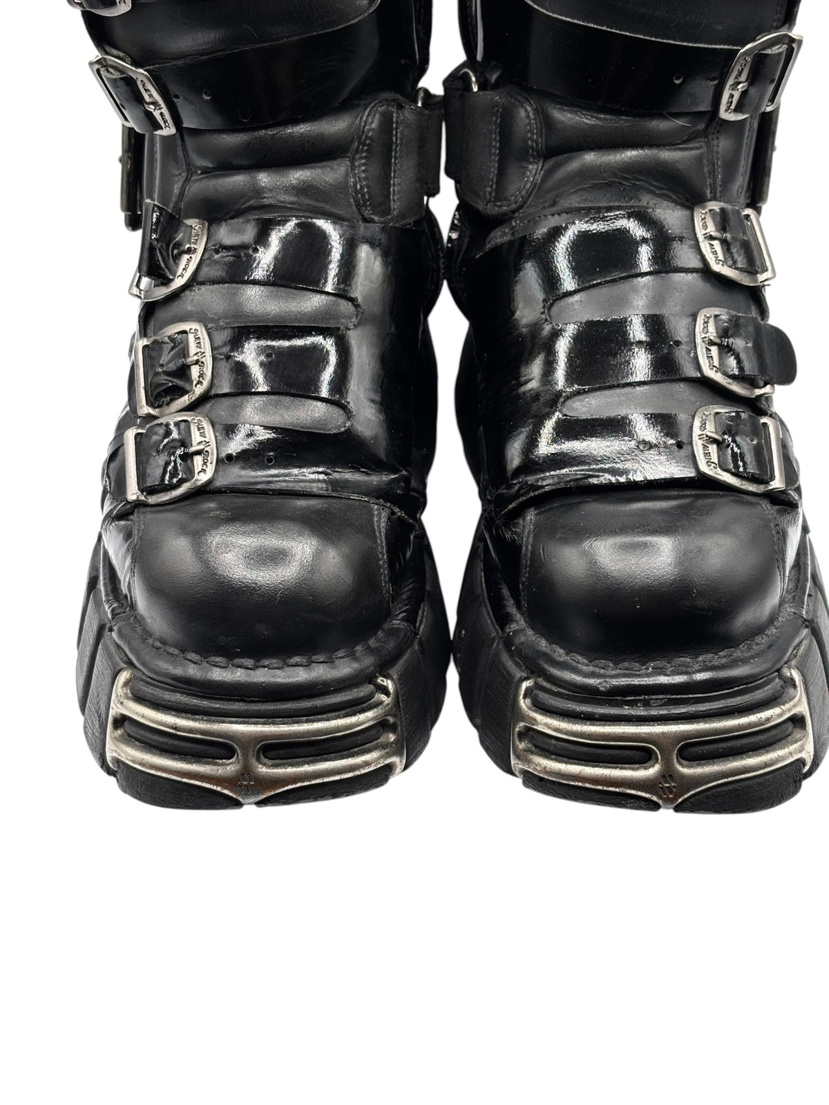 Vintage black leather boots front view with triple buckle straps and silver-toned soles