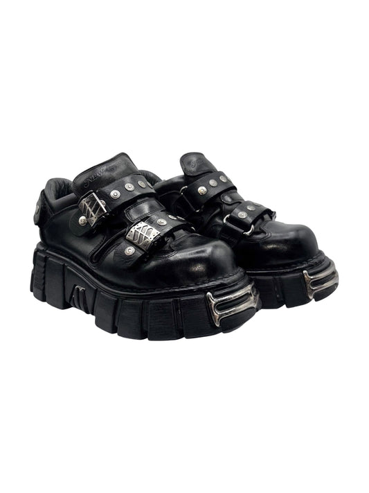Black studded strap platform boots with buckled ankle straps and chunky sole