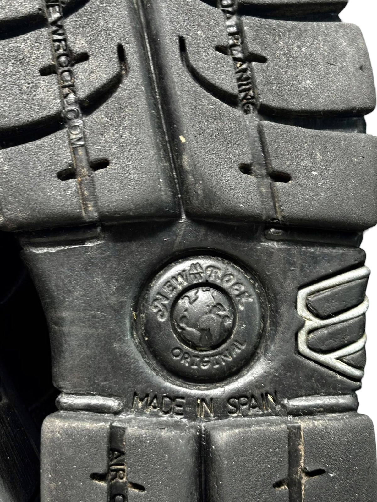 Black platform boots close-up with brand emblem and laced side detail