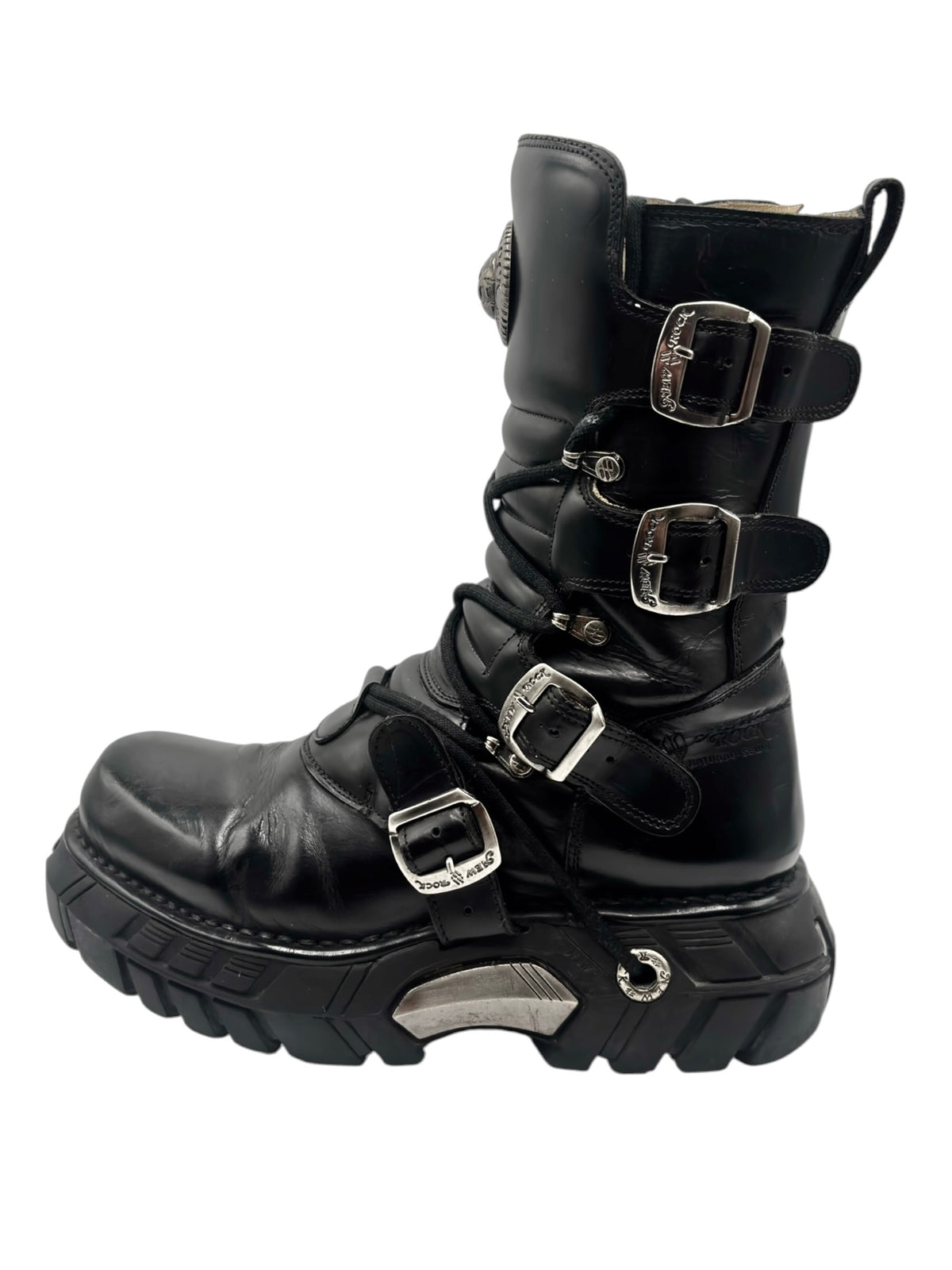 Black leather platform boots with multiple buckles and thick tread sole, side view.