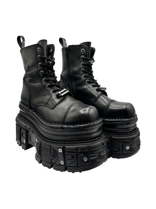 Black leather lace-up platform boots angled view, showing high stacked sole and lugs