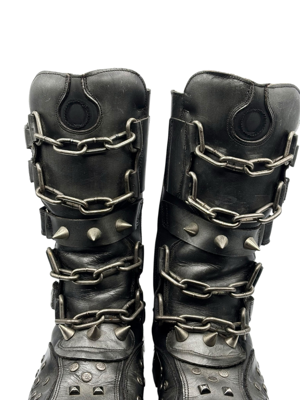 Vintage studded chain boots close-up with chain straps and circular pull-tab details