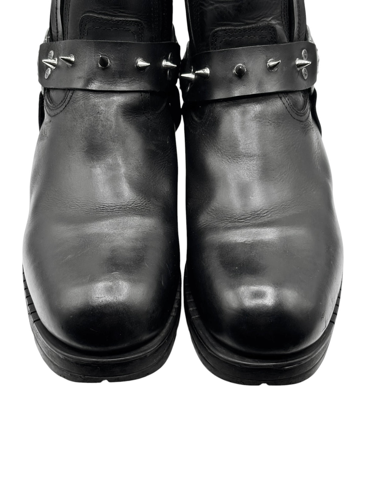 Black leather biker boots front view with metal spike straps and rounded toe
