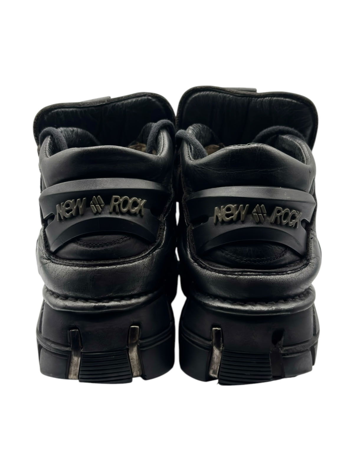 Back view of black platform boots with heel pull tabs and “New Rock” straps