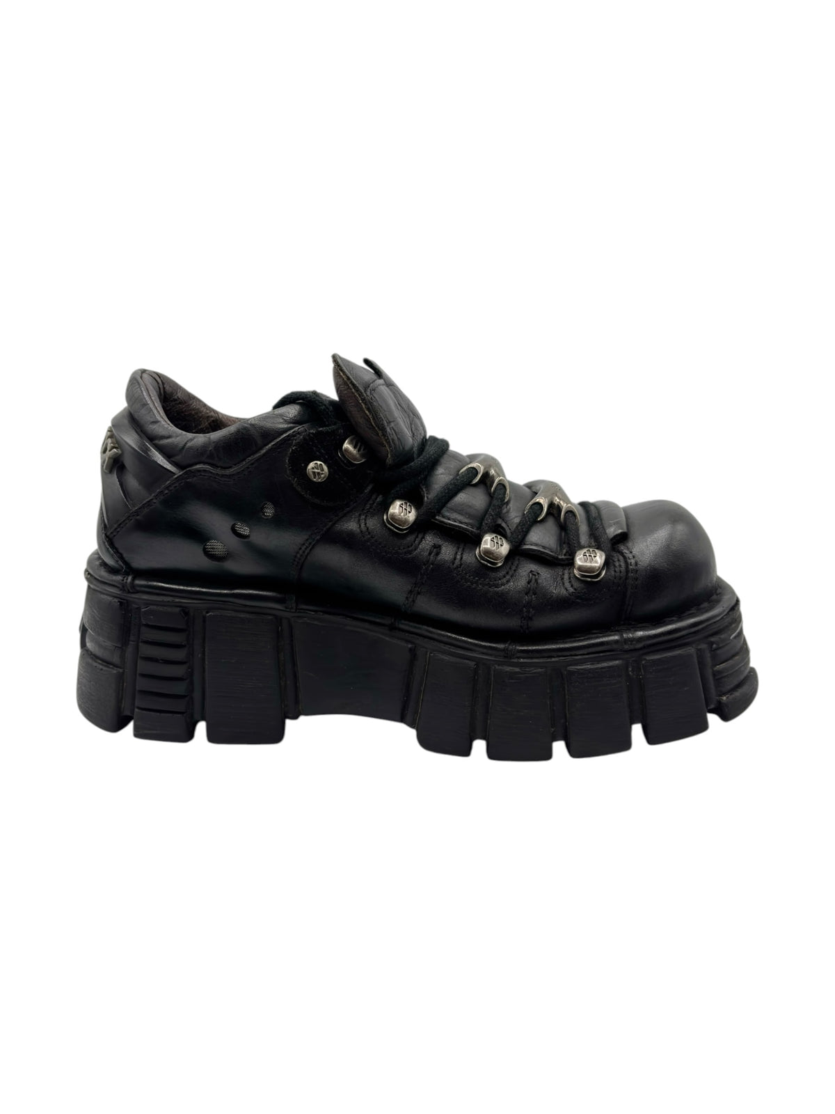 Vintage black platform boots with layered panel detailing, lace-up closure, and lug sole.