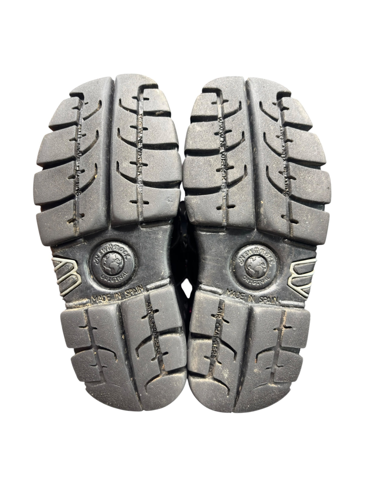 Black platform boots outsole view with tread and brand medallion