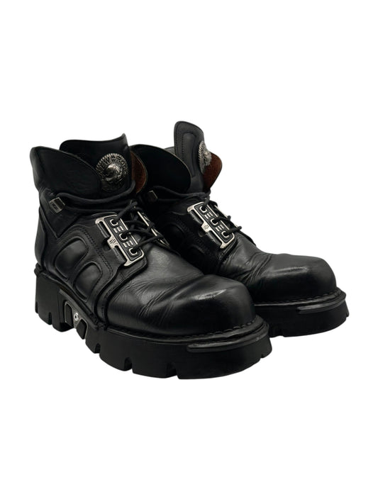Pair of black combat ankle boots with lace-up front and thick lug sole