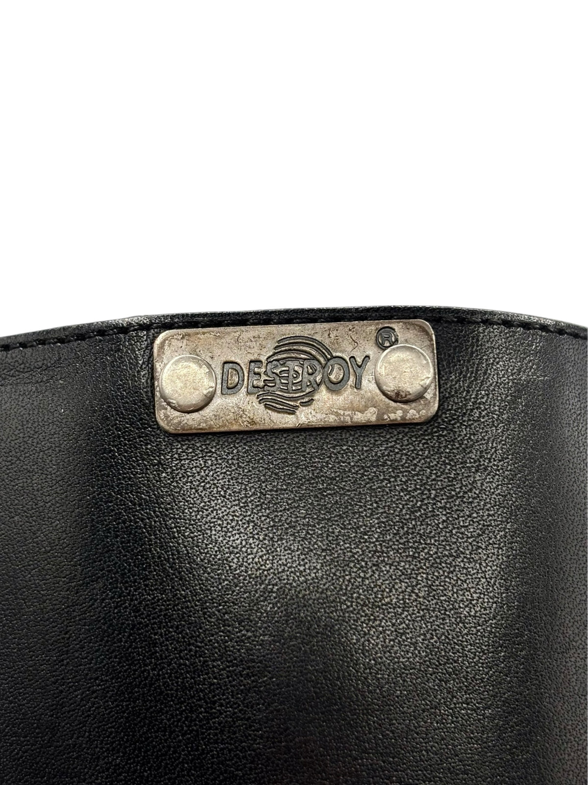 Back collar of black boots with metallic DESTROY logo plate