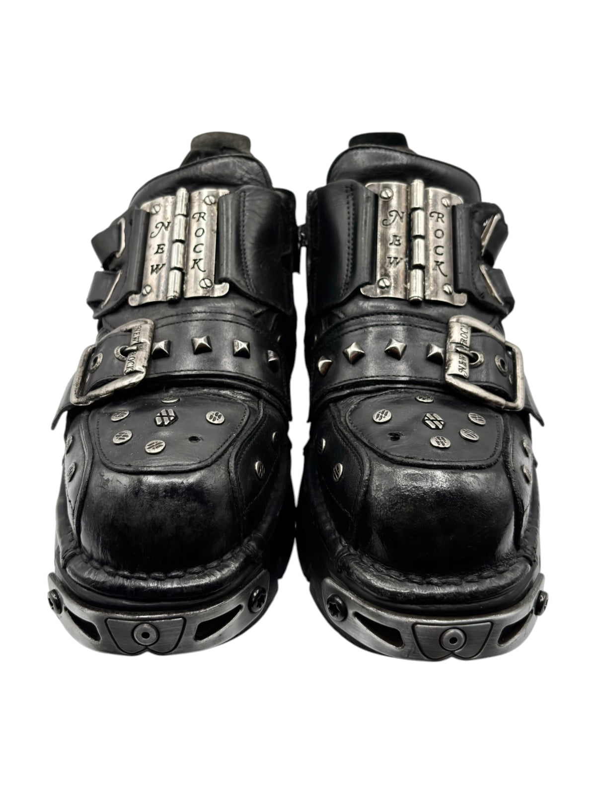 Black platform boots with metal plaque straps, studded toe caps, chunky tread sole