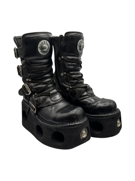 Black leather platform boots with cutout sole and side buckle straps
