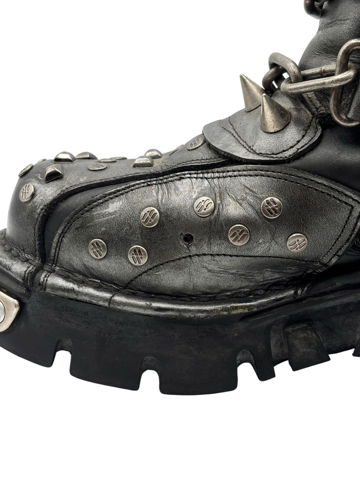 Vintage studded chain boots side view with stitched panels and buckle strap detail