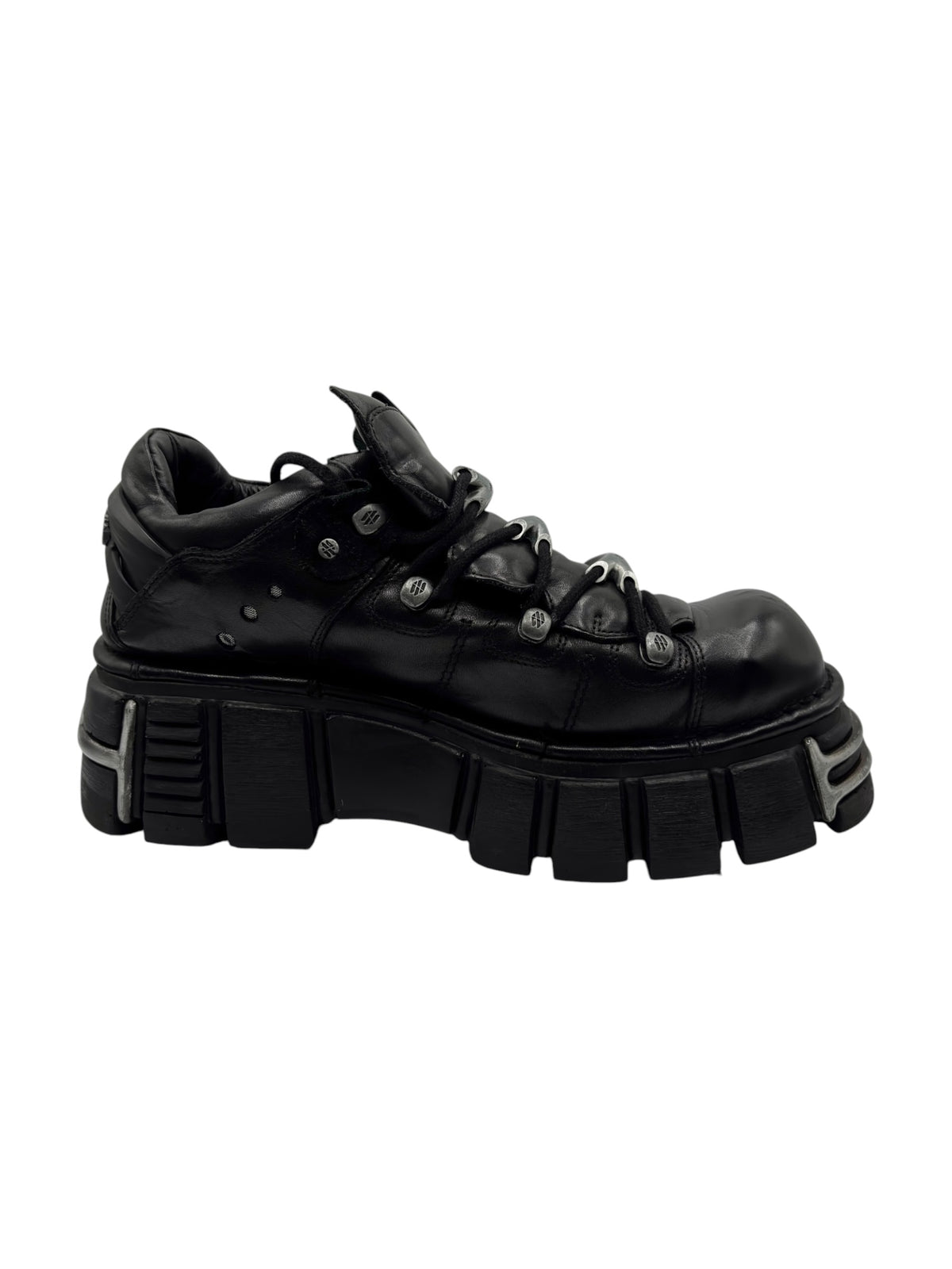 Black lace-up platform boot in side view with chunky tread sole