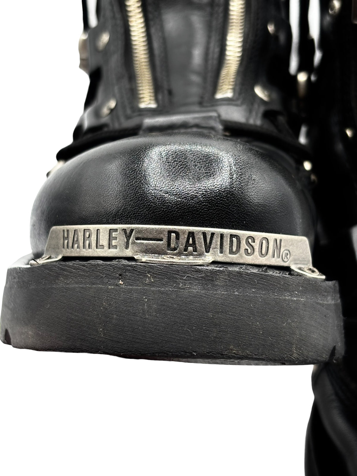 Black leather biker boot toe with Harley-Davidson logo on the front sole
