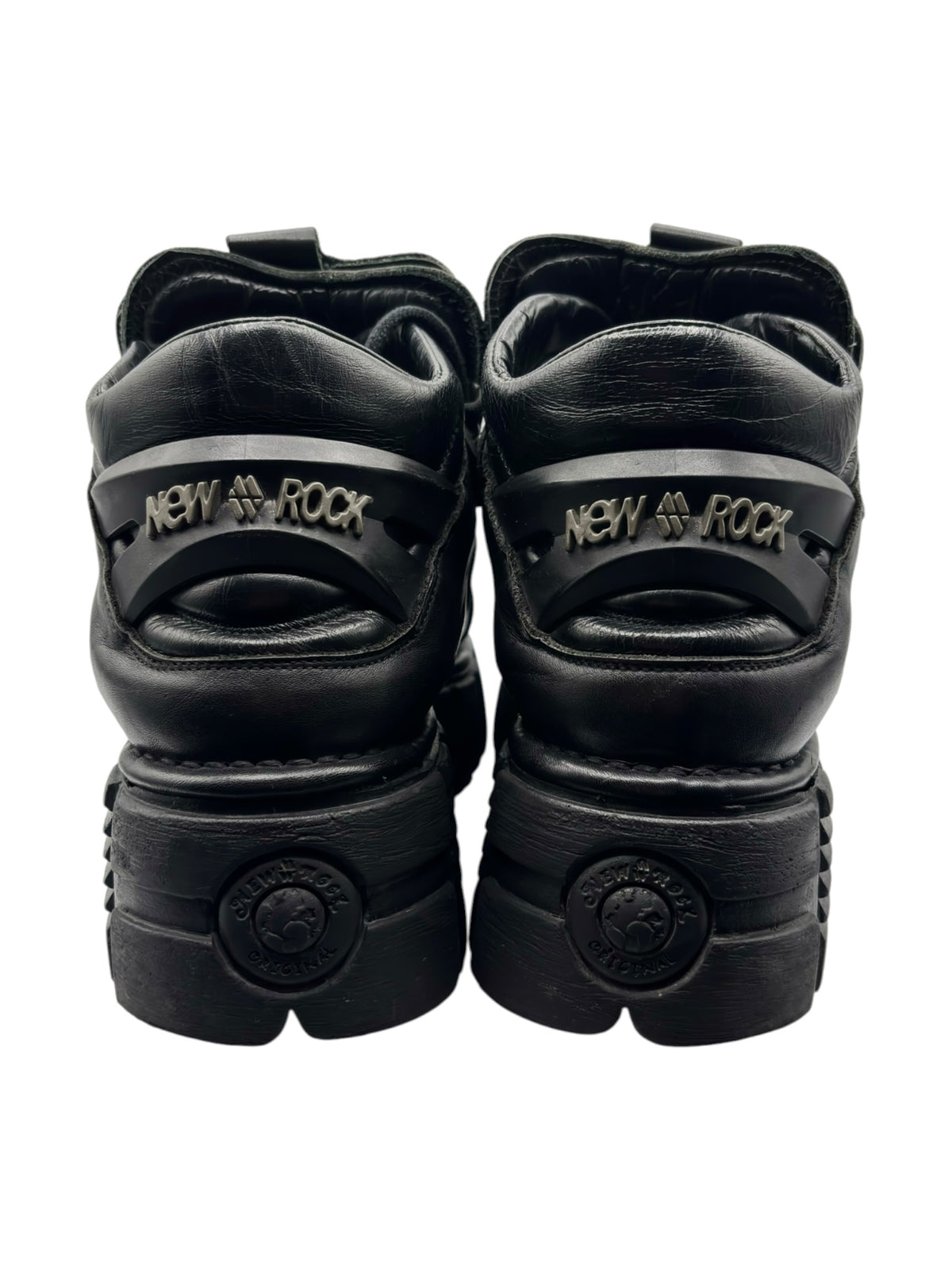 Back view of black platform boots with NEW ROCK logo on heel and rear cushion