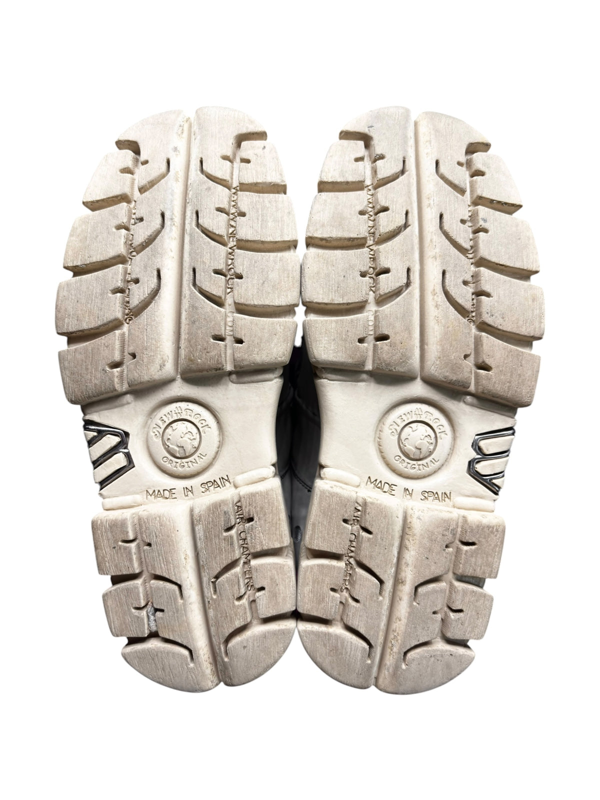 Pair of beige platform boot soles, showing deep tread pattern and “MADE IN SPAIN”