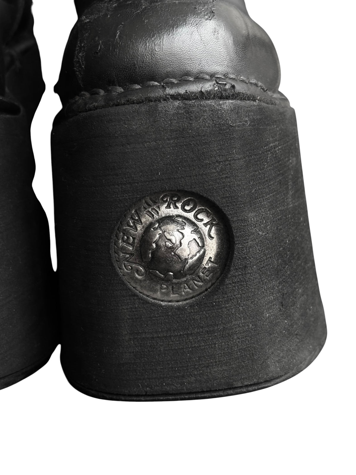 Knee-high platform boot heel detail with round New Rock logo badge