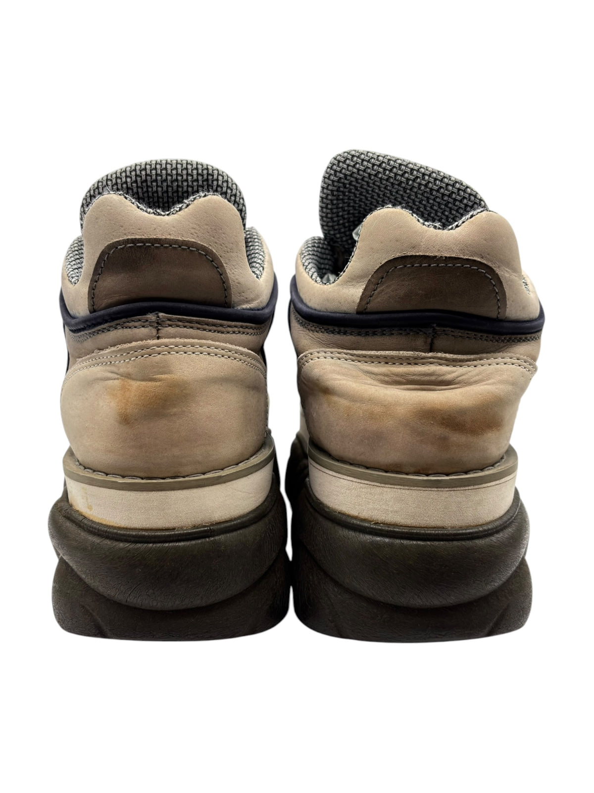 Back view of beige platform boots showing dark heels, seam details, and textured lining