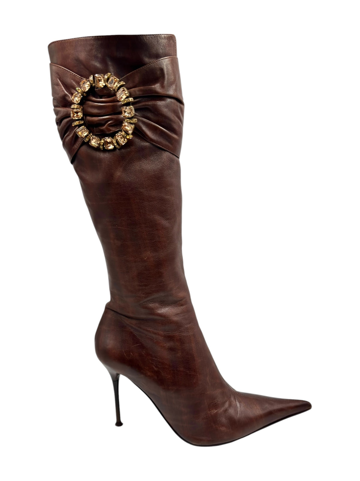 Dark brown knee-high leather boots with pointed toe and ornate front cuff brooch