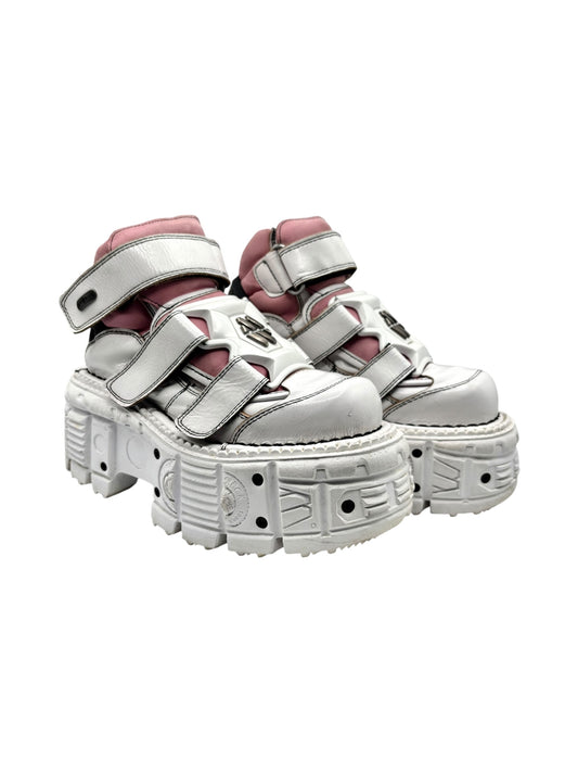 Pair of white platform boots with pink collar and silver hook-and-loop strap details