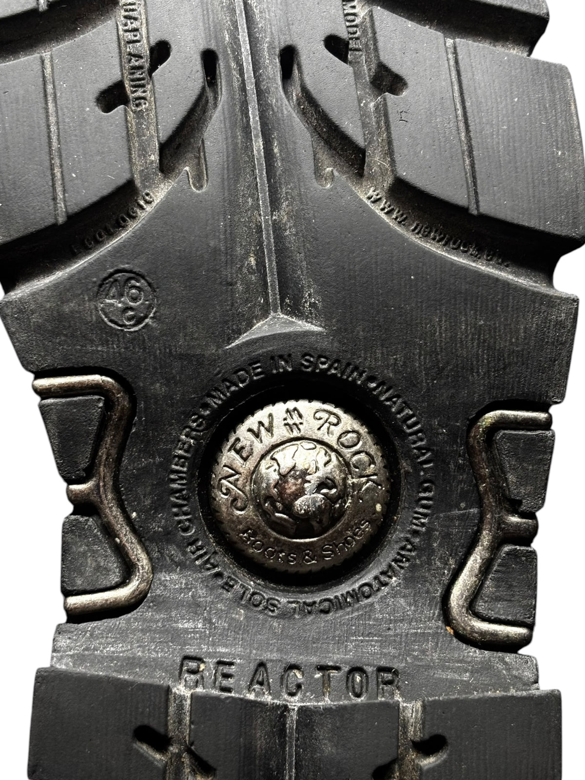 Metal outsole plate detail for reactor-style ankle boots, marked “REACTOR”