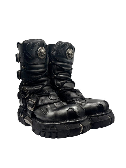 Vintage platform boots, angled side view with black leather straps, buckles, and thick lug sole