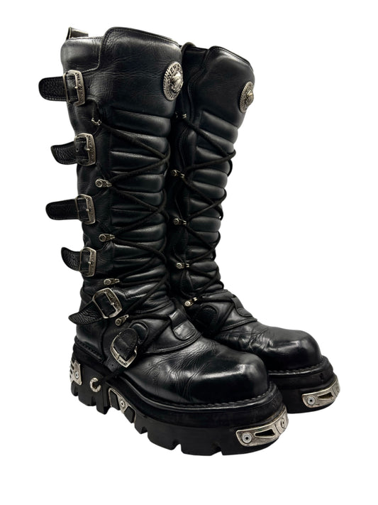 Black knee-high leather boots with multiple side buckles and rugged tread sole