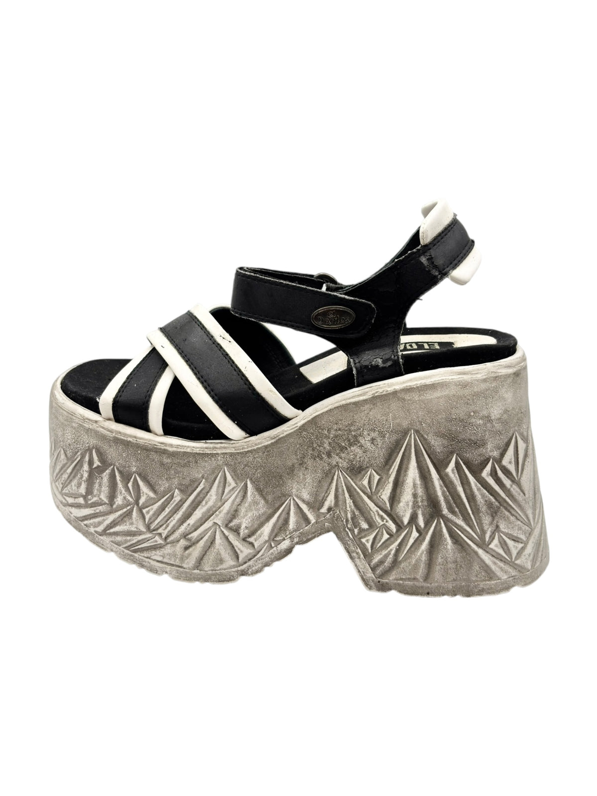 Black-and-white strappy platform sandals with silver textured geometric wedge