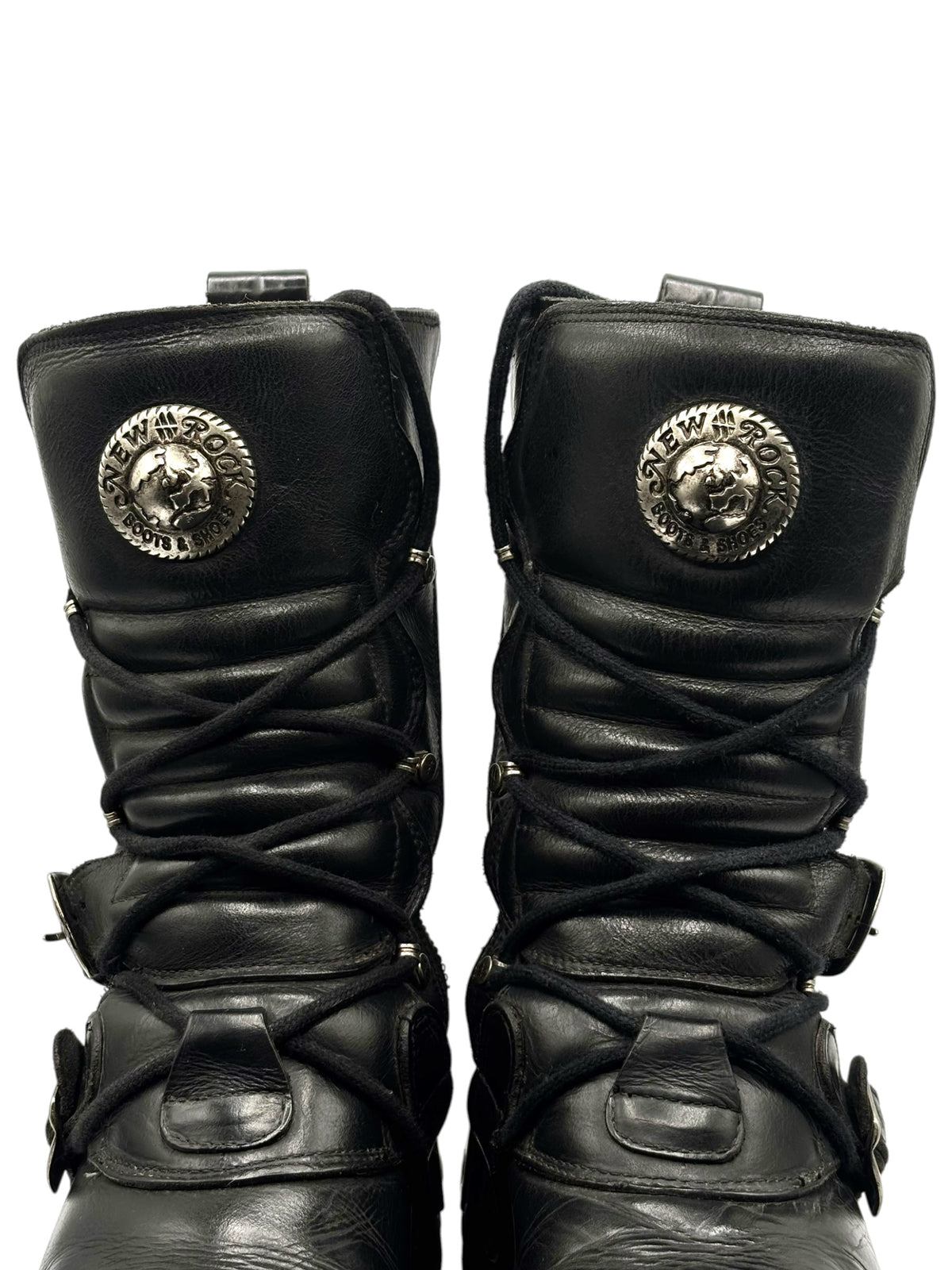 Front view of black mid-calf reactor boots with round emblem patches on uppers
