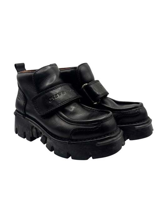Black leather platform boots with Velcro strap and chunky lug sole, side angle