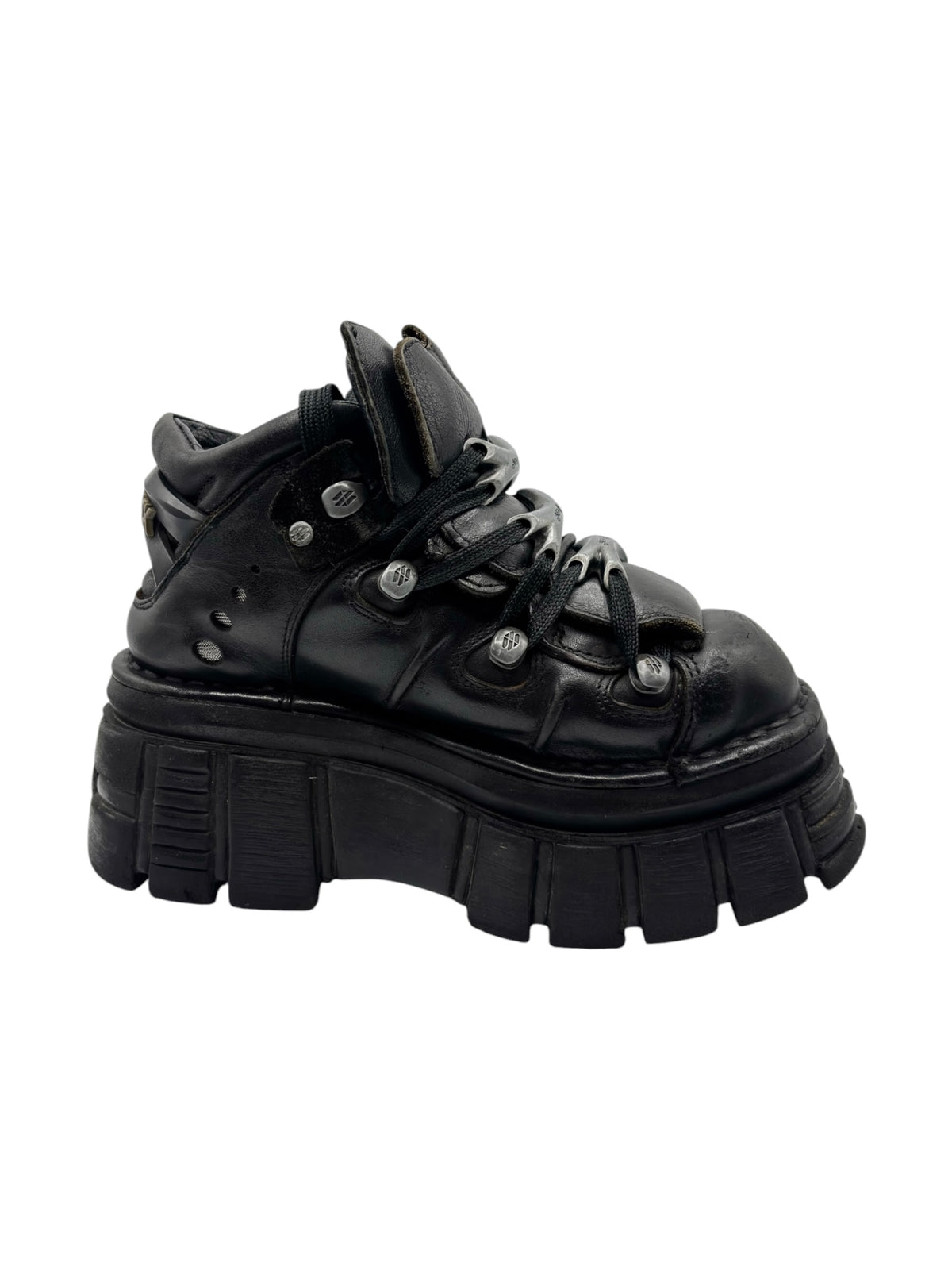 Black high-top platform boots with lace-up closure and stud accents