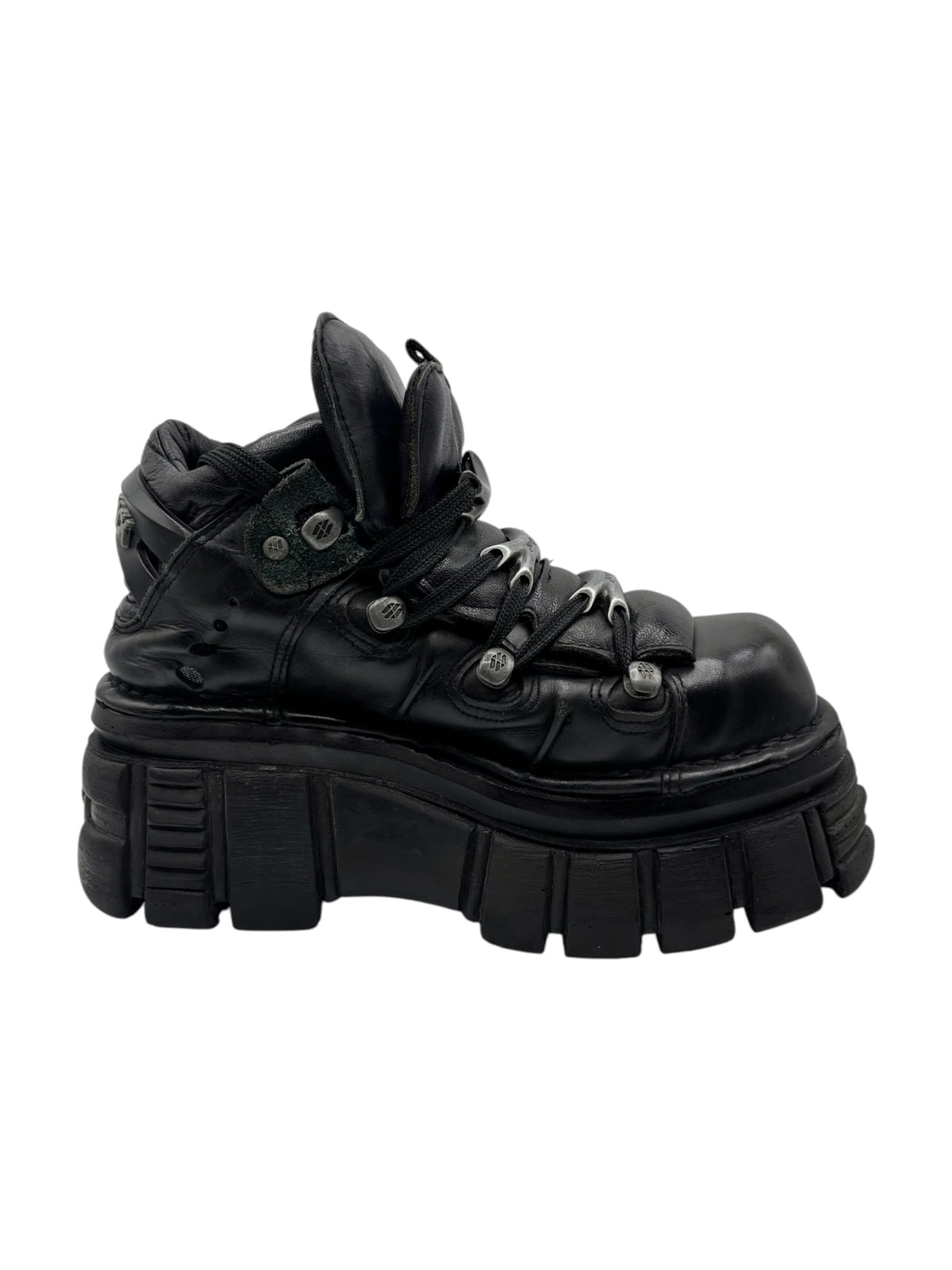Black leather lace-up platform boots with side straps, metal eyelets, and bulky sole.