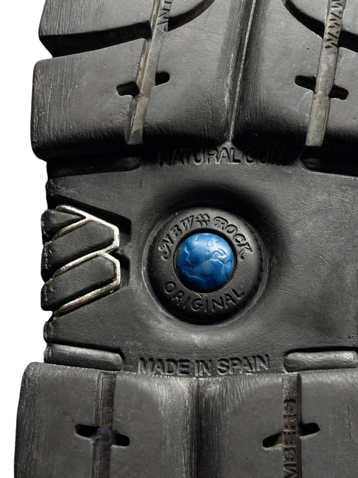 Black platform boot outsole close-up with blue logo and Made in Spain text