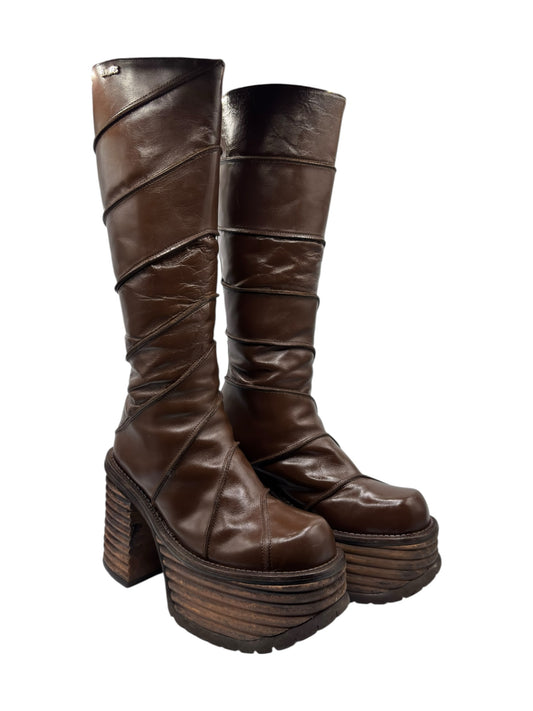 Brown knee-high platform boots with thick block heel, rounded toe, side seams