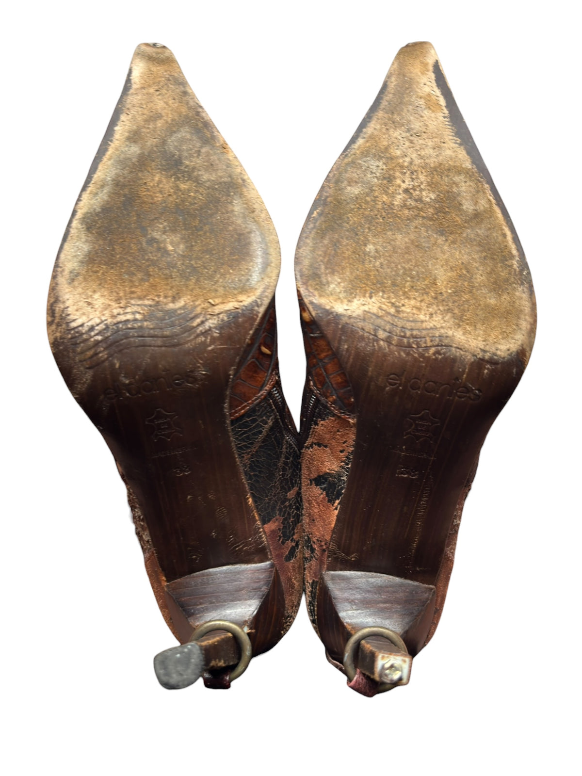 Back view knee-high boots with tan soles and small brass heel buckles.
