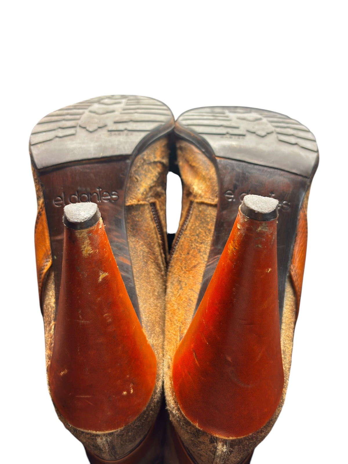 Vintage leather heel bottoms showing deep tread and heel-toe wear