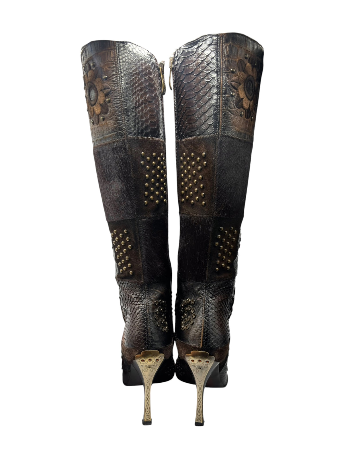 Pair of vintage knee-high leather boots with pointed toe, studded panels, and floral accents