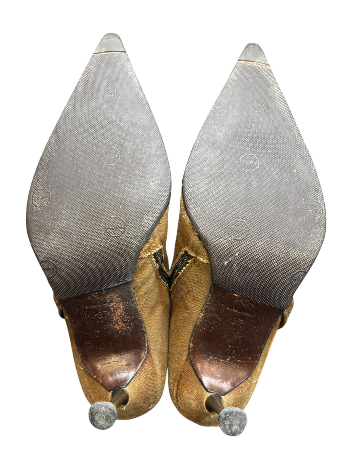 Bottom view of tan knee-high boots with rubber pebbles on heel