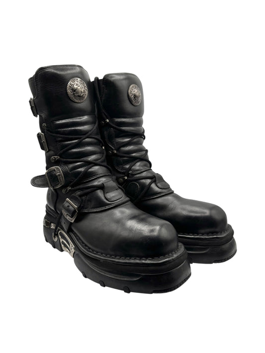 Black mid-calf platform boots with lace-up front, buckles, and thick tread sole.