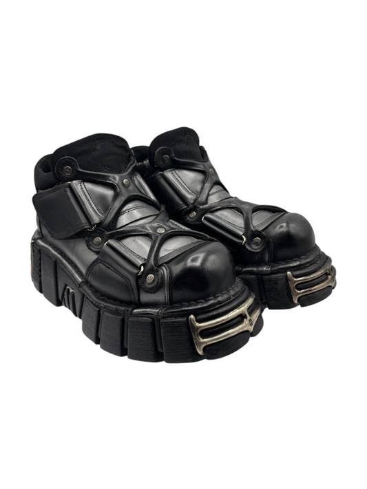 Black chunky leather platform boots with buckled straps and gold-tone side buckles