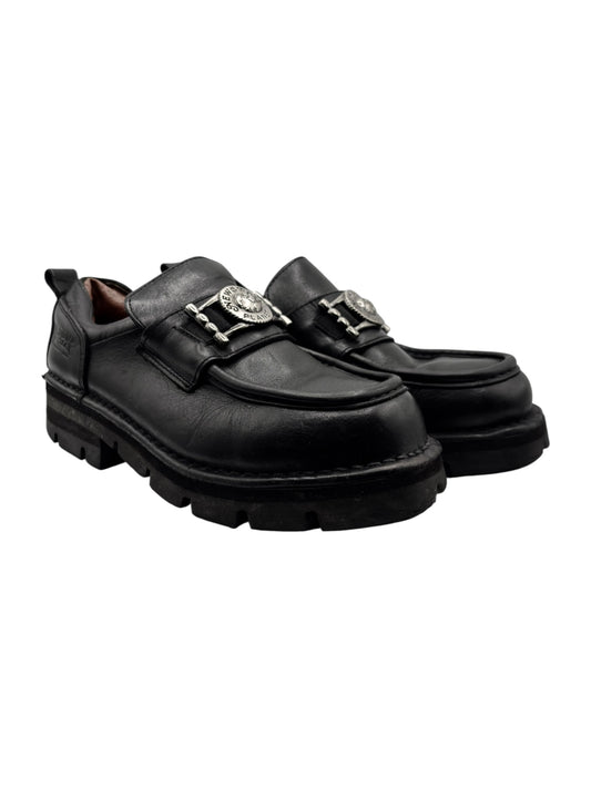 Black leather loafers, side view, double buckled straps and thick treaded sole