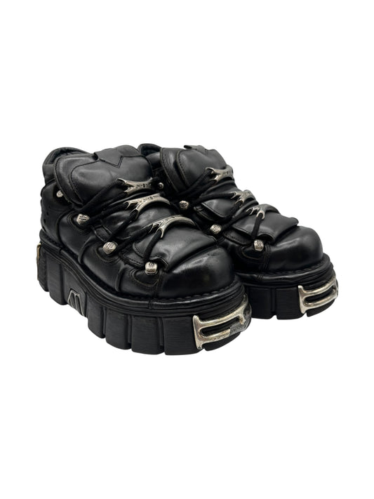 Black leather platform lace-up boots with chunky sole and gold-tone trim