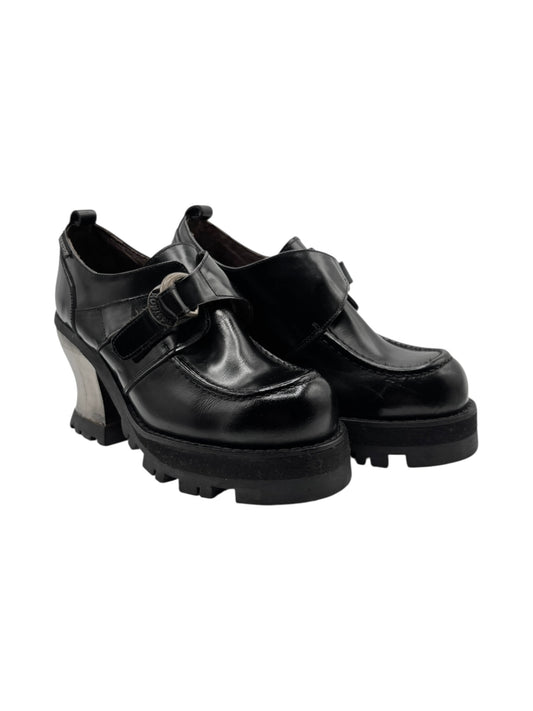 Black leather platform loafers with adjustable strap detail and lug sole